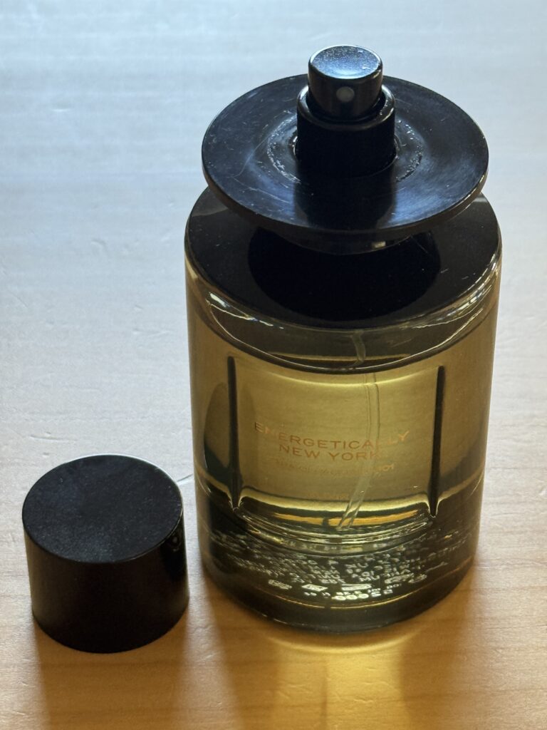 Close-up of Zara Energetically New York Elixir bottle with magnetic cap removed, showing cap and bottle design detail
