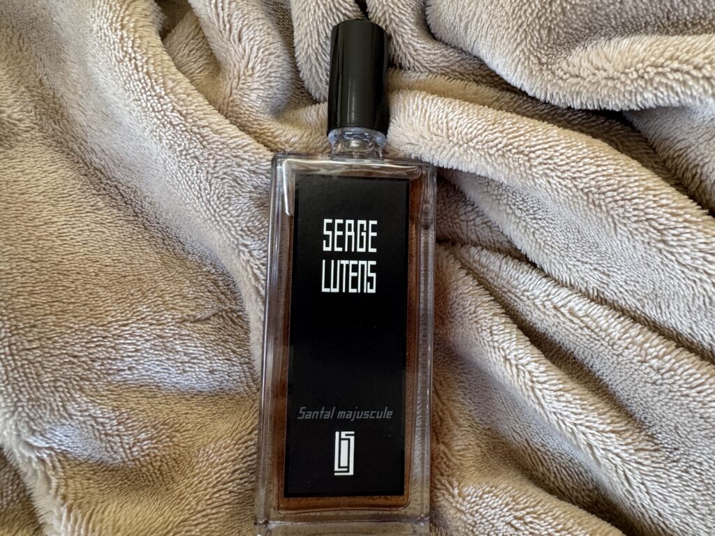 Serge Lutens Santal Majuscule perfume bottle on soft blanket