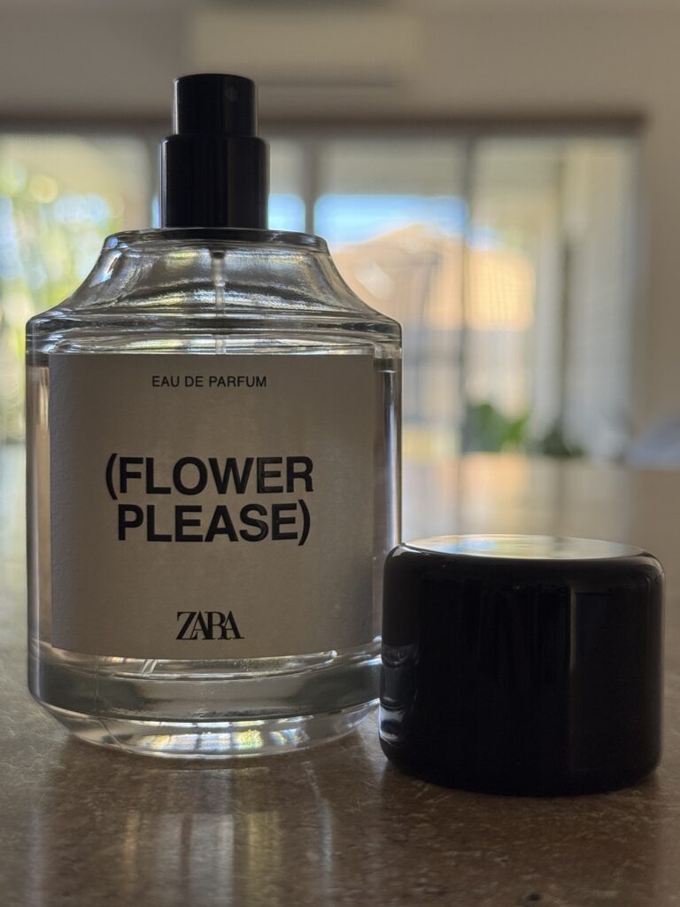 Zara Flower Please perfume bottle with cap placed beside it photographed indoors in natural light