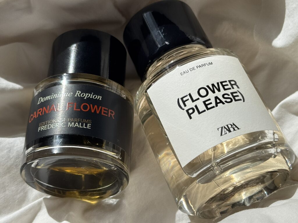 Frederic Malle Carnal Flower and Zara Flower Please white floral perfumes placed on a white bed