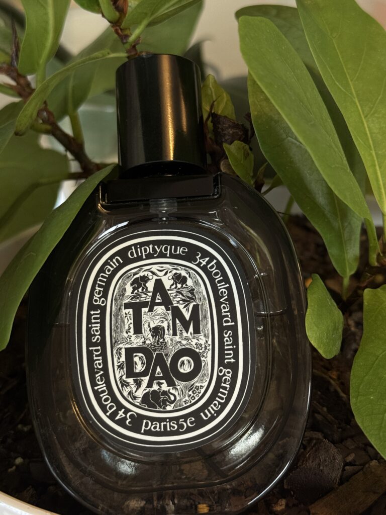 Diptyque Tam Dao EDP bottle photographed on grass outdoors